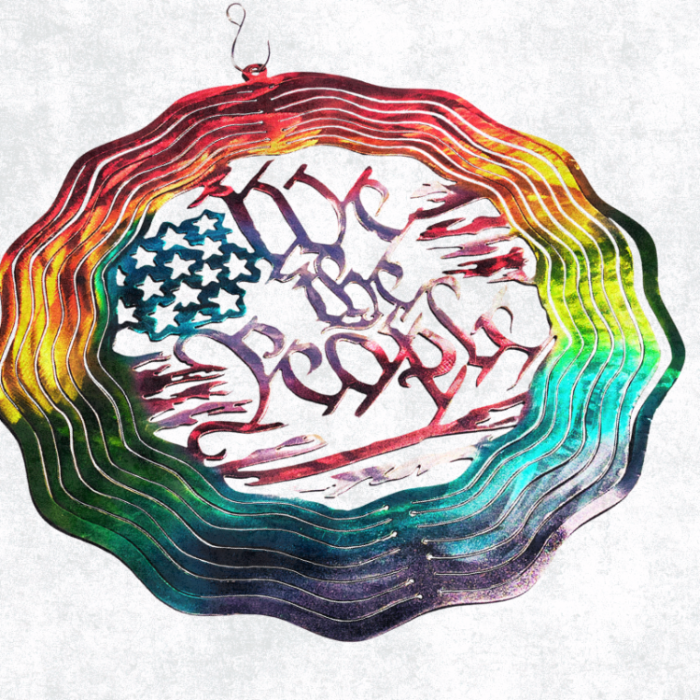 Metal Art Wind Spinner with gay pride Colors, American Flag tattered shapes, "We the people" displayed in the middle. Red, orange, yellow, green, blue and purple colors airbrushed onto steel. Rotating wind spinner 