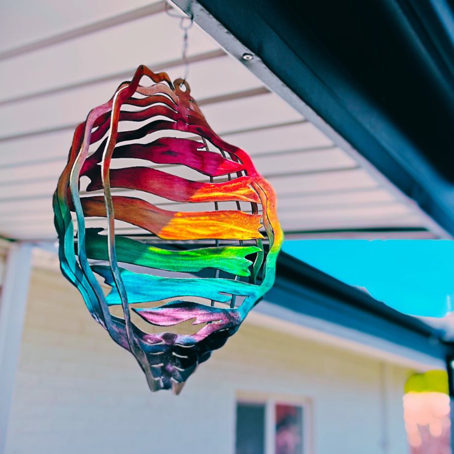 Metal Art 3d wind spinner, painted with rainbow gradient. Colors represents gay, lesbian, queer, trans, bisexual, and other minority groups. 